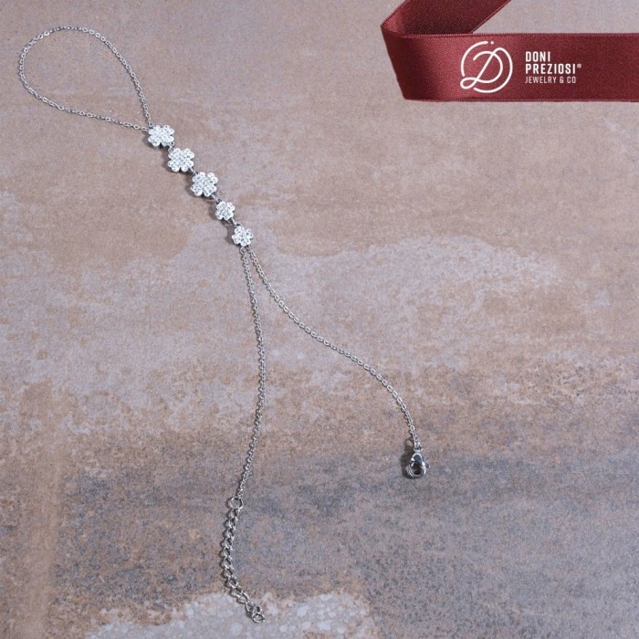 Baciamano in acciaio donna con quadrifogli zirconati