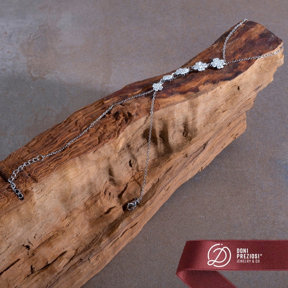 Baciamano in acciaio donna con quadrifogli zirconati