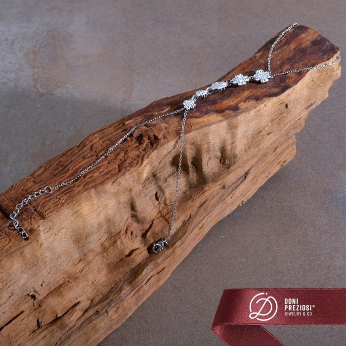 Baciamano in acciaio donna con quadrifogli zirconati